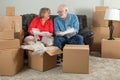 Senior Adult Couple Packing or Unpacking Moving Boxes Royalty Free Stock Photo