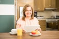 Senior adult having breakfast holding a tablet Royalty Free Stock Photo