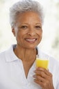 Senior Adult Holding A Glass Of Fresh Orange Juice