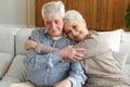 Senior adult mature couple hugging at home. Mid age old husband and wife embracing with tenderness love enjoying sweet Royalty Free Stock Photo