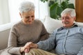 Senior adult mature couple in love holding hands at home. Mid age old husband and wife looking with tenderness love Royalty Free Stock Photo