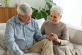 Senior adult mature couple in love holding hands at home. Mid age old husband and wife looking with tenderness love Royalty Free Stock Photo