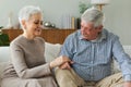 Senior adult mature couple in love holding hands at home. Mid age old husband and wife looking with tenderness love Royalty Free Stock Photo