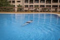 Senior adult swims in the pool. The concept of a healthy active lifestyle in old age Royalty Free Stock Photo