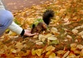 Senior adults feeding a little funny squirrel  in the park in spring. Wild animals, lend a hand theme.  Close up Royalty Free Stock Photo