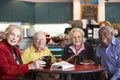 Senior adults having morning tea together