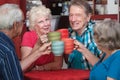 Senior Adults Toasting with Mugs