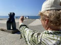 Senior adventure is ageless woman with a mobile phone take a photo sights of Albania Durres near sea beach in summer day. Summer