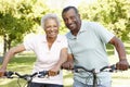 Senior African American Couple Cycling In Park Royalty Free Stock Photo