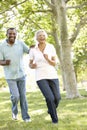 Senior African American Couple Running In Park