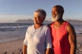 Senior african american couple smiling while standing on the beach Royalty Free Stock Photo