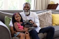 Senior African American man and his granddaughter using vr headset Royalty Free Stock Photo