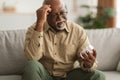 Senior African American Man Holding Medical Pills Reading Instruction Indoor Royalty Free Stock Photo