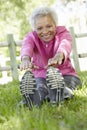 Senior African American Woman Exercising In Park Royalty Free Stock Photo