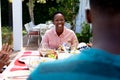 Senior African American woman and her family spending time together in the garden Royalty Free Stock Photo