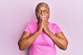 Senior african american woman wearing casual clothes and glasses shocked covering mouth with hands for mistake Royalty Free Stock Photo
