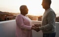 Senior african couple dancing outdoors at summer sunset - Focus on woman face Royalty Free Stock Photo