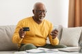 Senior African Male Shopping Using Credit Card And Smartphone Indoor Royalty Free Stock Photo