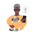 senior african man with a tiny dog searching for veterinarian online from smartphone. Royalty Free Stock Photo