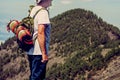 Senior aged man hiker admiring the view from the top of the mountain in adventure backpack trekking tour - active healthy mature Royalty Free Stock Photo