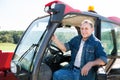 Senior aged man working on small farm tractor Royalty Free Stock Photo