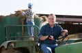 Senior aged man working on small farm tractor Royalty Free Stock Photo