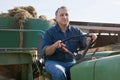 Senior aged man working on small farm tractor Royalty Free Stock Photo
