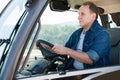 Senior aged man working on small farm tractor Royalty Free Stock Photo