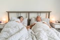 Senior aging married couple man male and female woman deep sleep together in bed apartment goog relationship and love