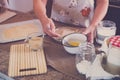 Senior alone at home cooking fish at the kitchen -  very focused indoor - mature and caucasian 60s woman - retired woman Royalty Free Stock Photo