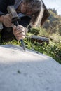 Senior artist carving in stone Royalty Free Stock Photo