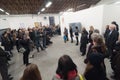 Senior artist giving speech to crowd at art gallery museum exhibition opening