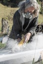 Senior artist working on a stone sculpture