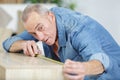 Senior as craftsman measuring wood at carpentry shop