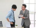 .Senior Asain businessman boss feel unhappy with serious face and argue with young junior employee. Daily problem from working in Royalty Free Stock Photo