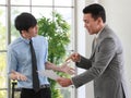 Senior Asain businessman boss feels angry and unhappy with serious face and argue with young junior employee. Daily problem from Royalty Free Stock Photo