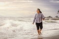 Senior Asia woman dancing on the beach