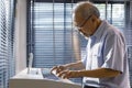 Senior Asian artist man playing and composing music with his piano alone in his retirement pension home for elder and musician Royalty Free Stock Photo