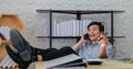 Senior Asian business men use smart phone and notebook computers for work from home.He is quarantined at home during the Royalty Free Stock Photo