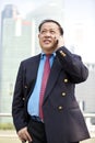 Senior Asian businessman using smart phone Royalty Free Stock Photo