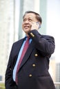 Senior Asian businessman using smart phone Royalty Free Stock Photo
