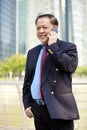 Senior Asian businessman using smart phone Royalty Free Stock Photo