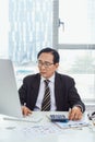 Senior asian businessman working at his office desk, business people, office lifestyle concept Royalty Free Stock Photo