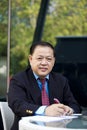 Senior Asian businessman writing proposal Royalty Free Stock Photo