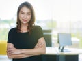 Senior Asian businesswoman standing in modern office crossed arms and looking to camera with self-confidence. Copy space in the Royalty Free Stock Photo