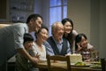 Senior asian couple celebrating wedding annversary with three generational family Royalty Free Stock Photo