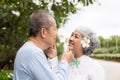 Senior Asian couple playing and teasing each other Happy family concept together outside the house Royalty Free Stock Photo