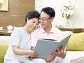 Senior asian couple reading a book together Royalty Free Stock Photo