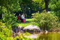 Senior Asian couple sittting on the bench and eating theri sanswiches at lachine rapides park in Montreal, Quebec, Canada