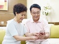 Senior asian couple using mobile phone Royalty Free Stock Photo